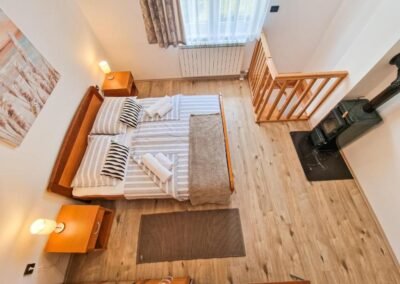 Double bedroom with a wood-burning stove