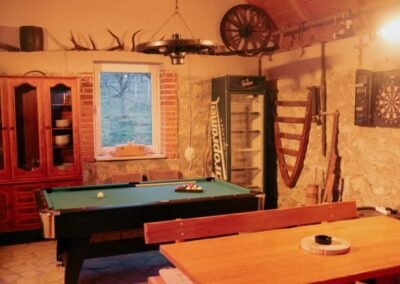 Billiards table and dartboard in the stone tavern