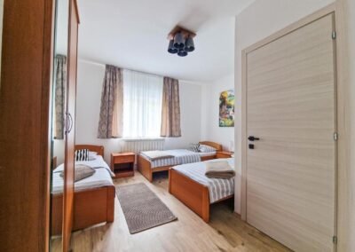 Bedroom with three single beds at Grga's Villa