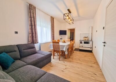 Living room with grey sofa and dining table