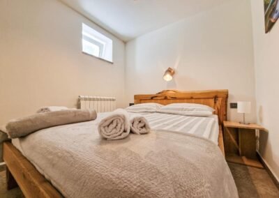 Double bed with folded towels at Grga's Villa
