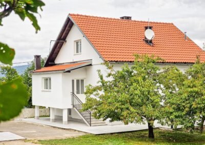 Grga's Villa with a red tiled roof and garden trees