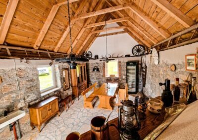 Stone tavern with a long dining table and timber roof