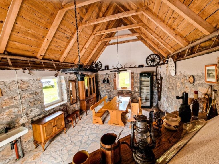 Rustic dining room with stone walls and a timber roof
