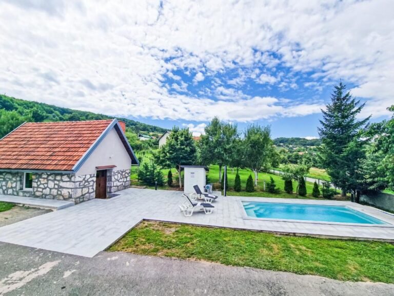 Pool terrace and stone tavern surrounded by trees