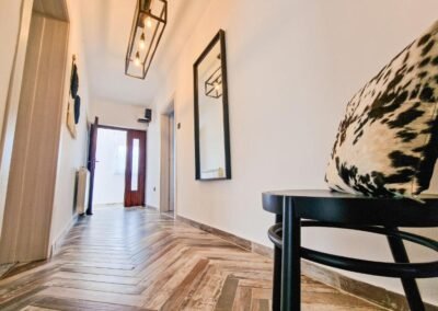 Entrance hallway with a chair and mirror