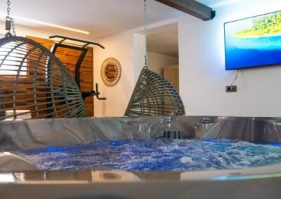 Indoor hot tub with hanging chairs at Grga's Villa