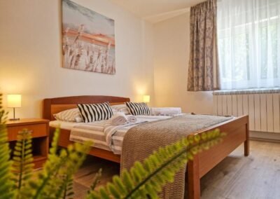 Double bedroom with striped bedding at Grga's Villa