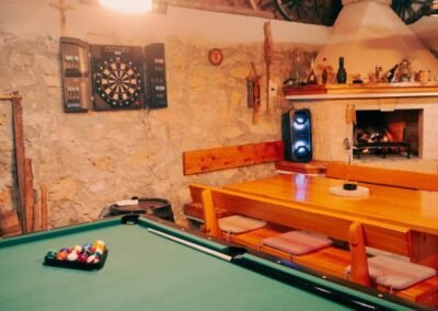 Games room with billiards table, dartboard and fireplace