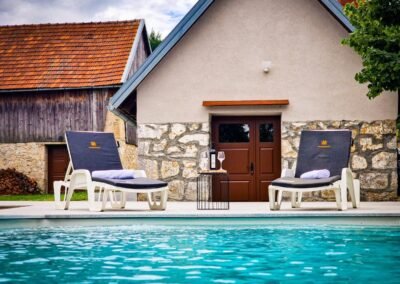 Sun loungers beside the pool at Grga's Villa